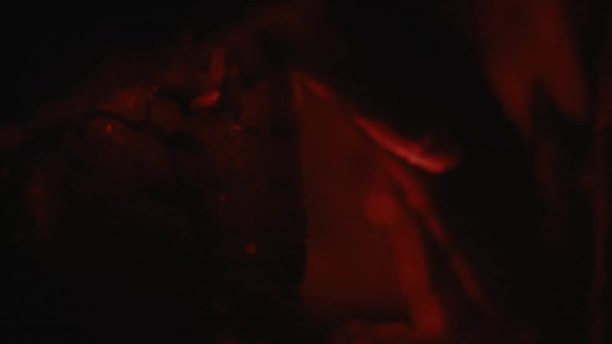 Sparks emerge from the burning embers of a fire