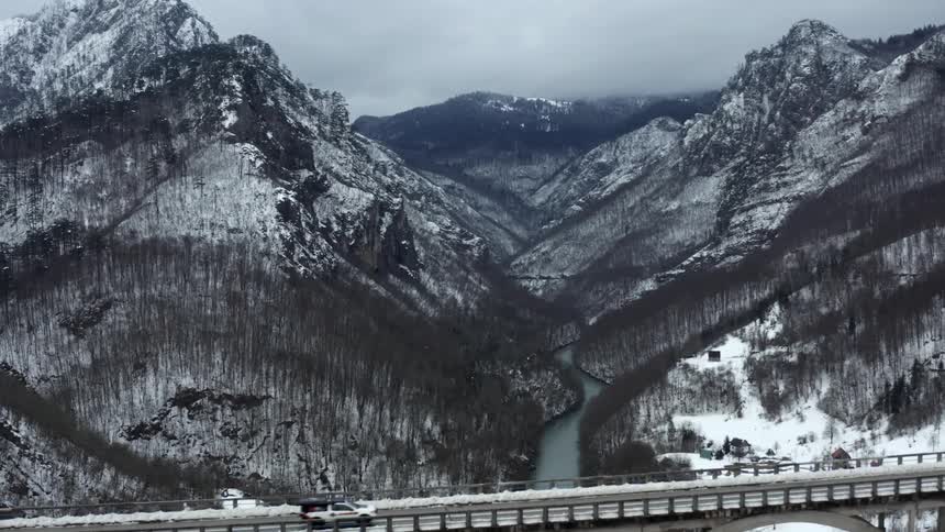 A bridge is before the mountain range