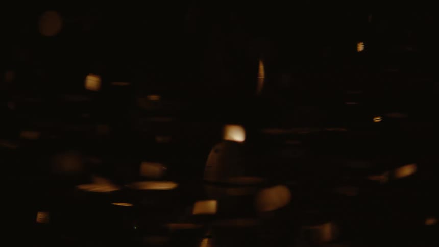 Closeup view of particles floating in a liquid with light reflecting through it creating an amber glow