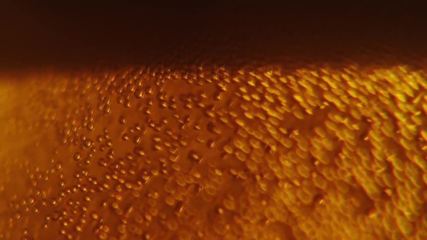 Gas bubbles inside beer rising up to the foam