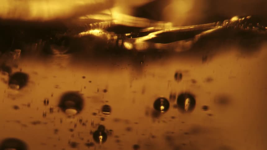 Bubbles moving and rising inside beer