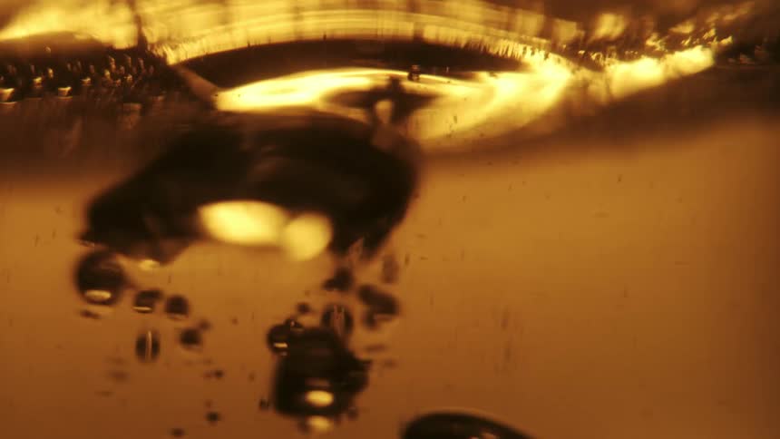 Bubbles rise to the top of a glass of beer