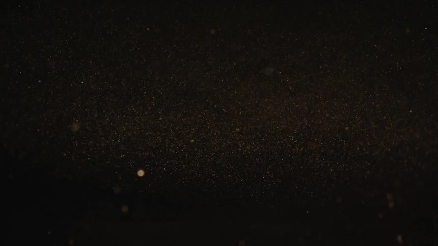Closeup view of bubbles slowly rising in a dark liquid