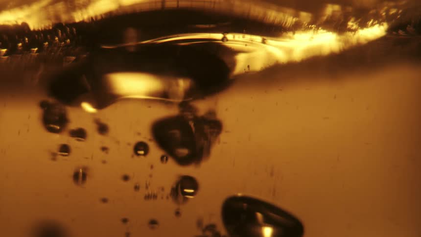 Beer is poured and bubbles float to the top