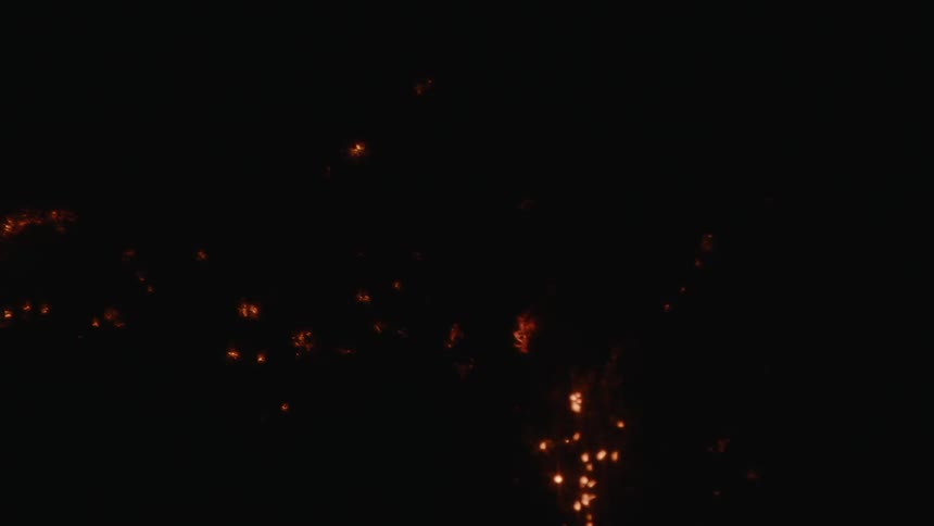 Sparks shine against a dark background during combustion