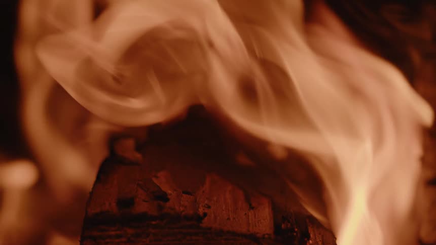 The campfire burns at night