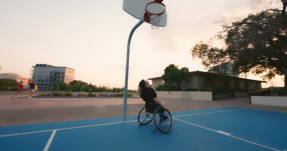 A teenage girl playing basketball by herself in a park