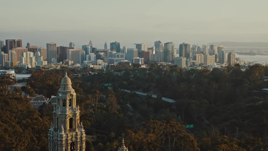 Establishing shot aerial view of San Diego's California Tower and downtown San Diego in the background