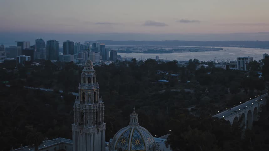 The sun is setting on the church and city in downtown San Diego