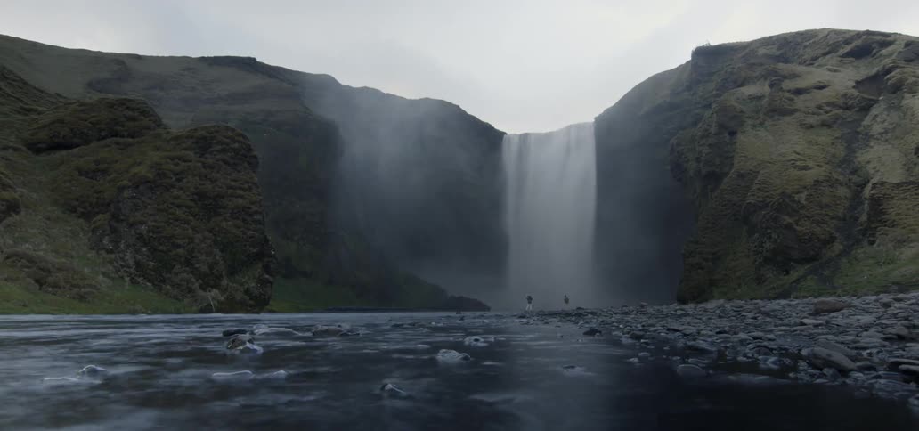 A waterfall sits between two large rock mountains