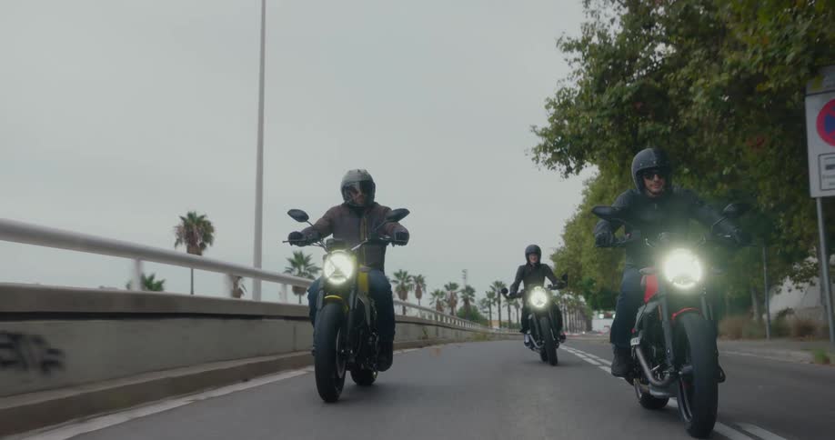 Three motorcyclists ride their motorbikes along the highway