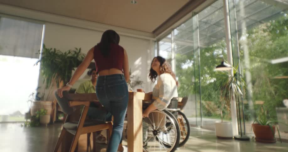 Three friends have coffee and talk at home