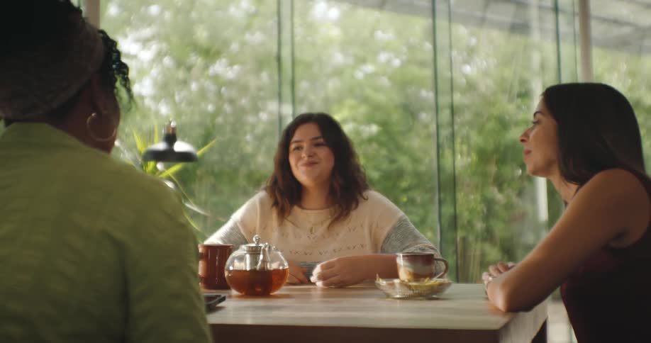 Women are talking and eating at the table