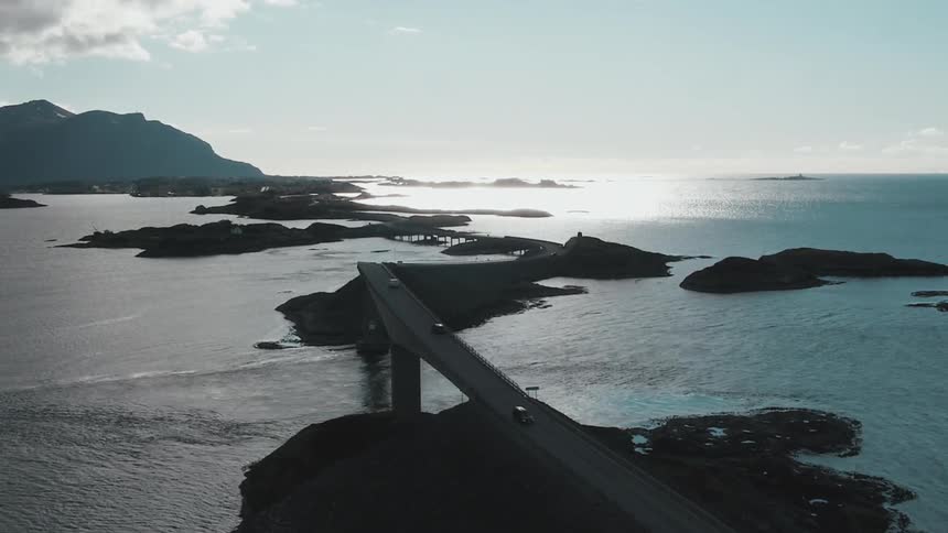 Several cars drive over a bridge