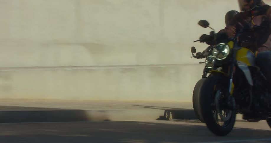 Group of motorcyclists on a ride along a city road on a sunny day