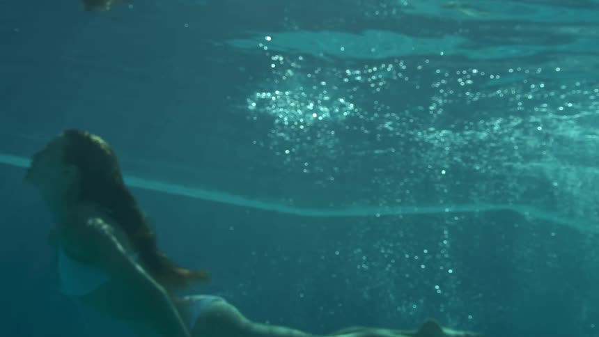 A teenage girl diving in a swimming pool