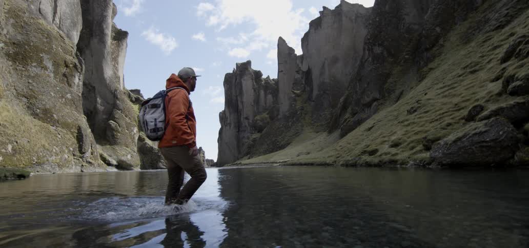 A man walks across a river