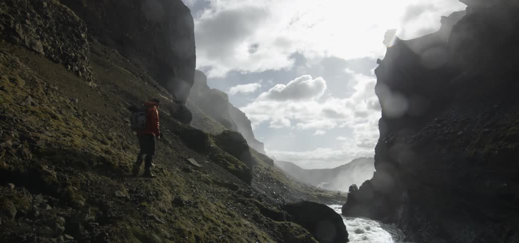 Person hiking next to a river