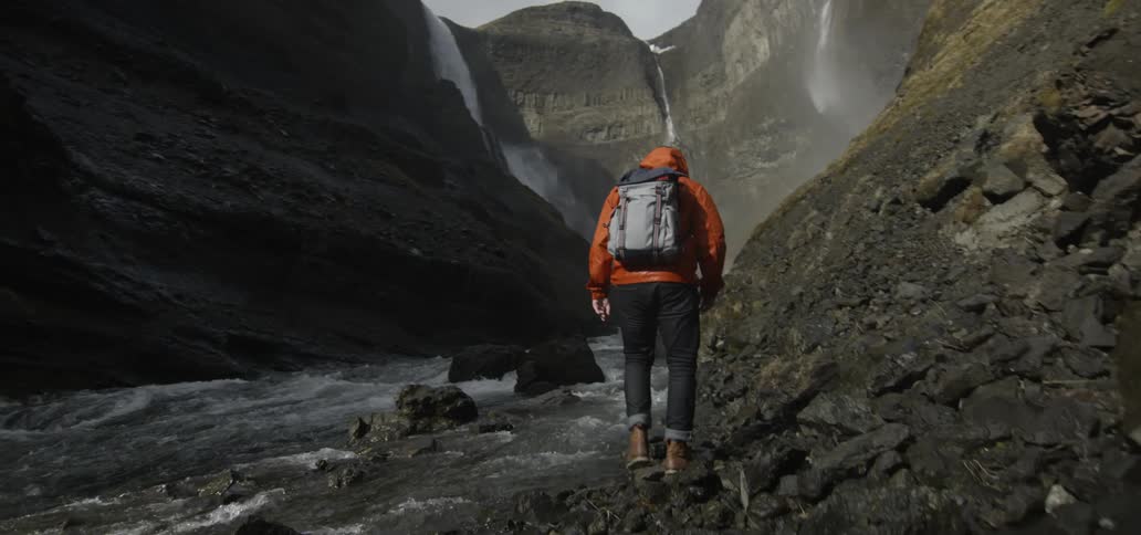 A hiker approaches a canyon river