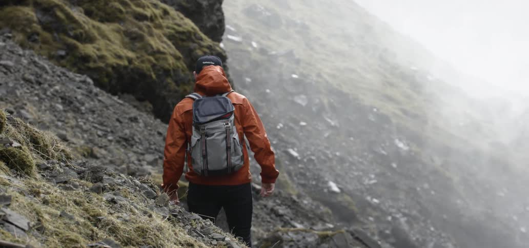 Hiker following a path on the side of a mountain