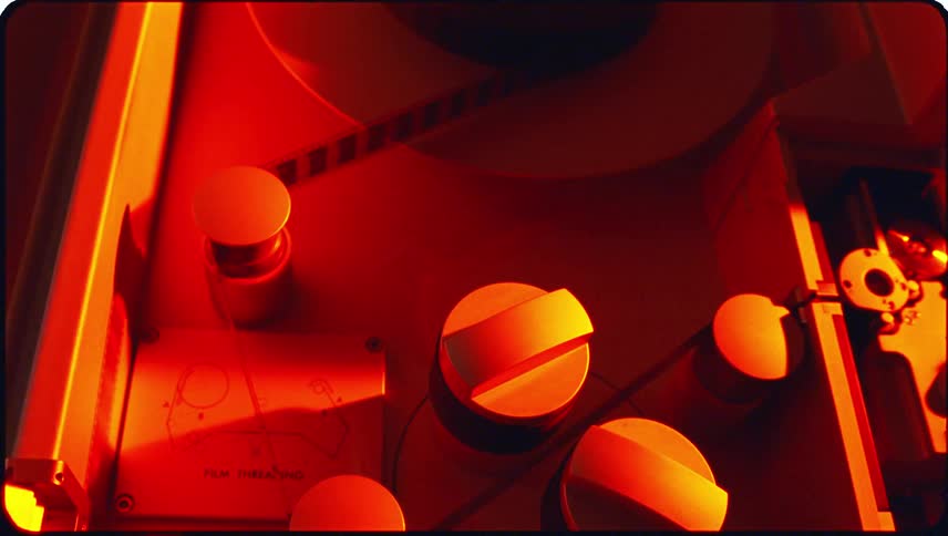 Closeup view of film threading equipment with cylindrical reels and components