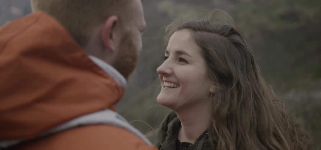Man and woman looking lovingly at each other outdoors in the wilderness