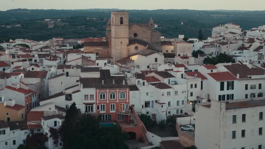 An old tower looms over a dense city