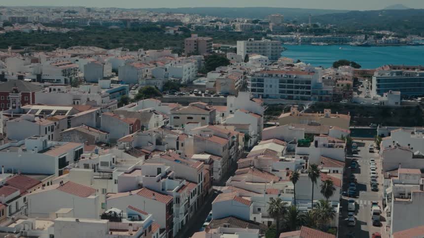An aerial view of a city neighborhood with allwhite houses and some mediumrise buildings