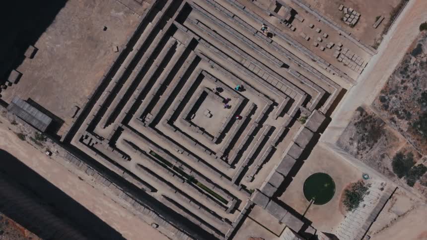 Several people navigate their way through a maze