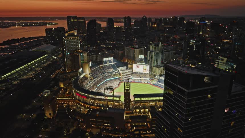 The camera flies through downtown San Diego to reveal a packed Padres baseball game at Petco Park