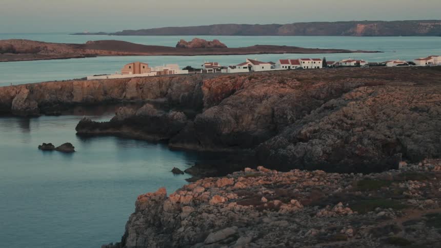 A small town sits on a rocky coastline