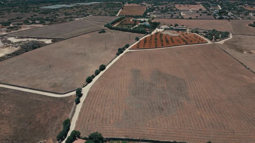 Aerial of roads leading through rural countryside and crop fields