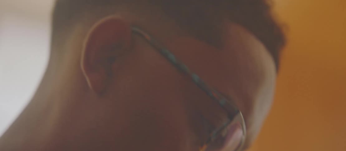 A young man nodding his head to music