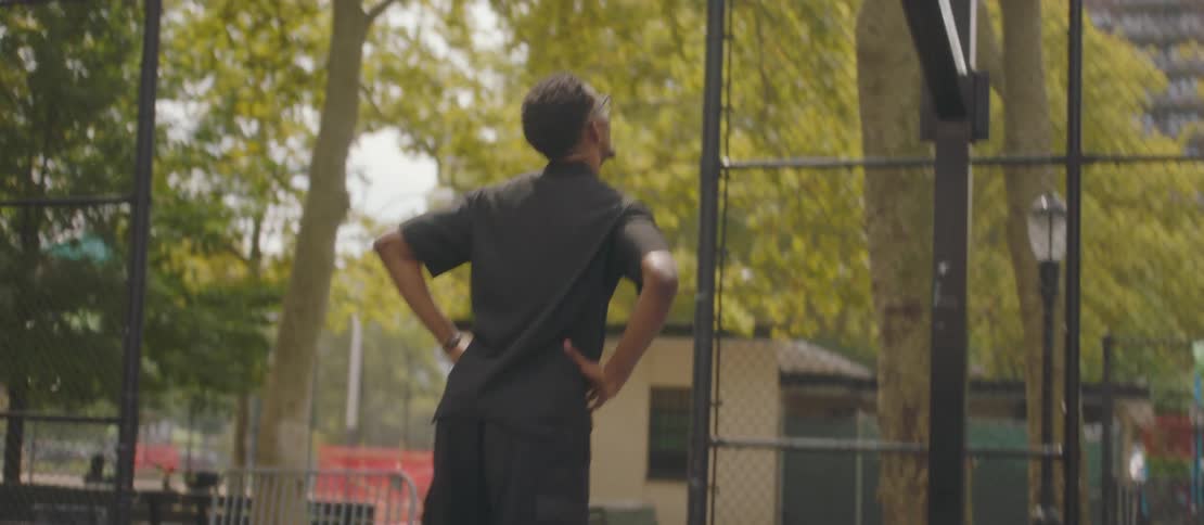 Young men playing basketball on an outdoor court