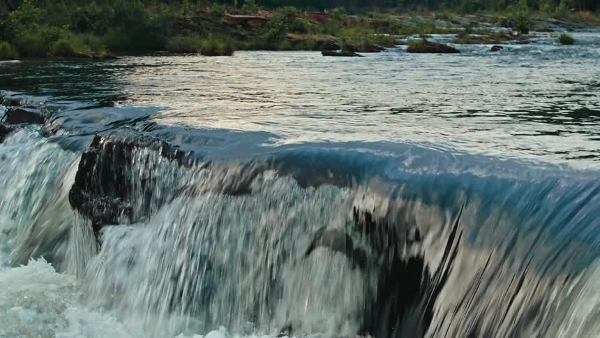 River flowing through rocks and surrounded by vegetation