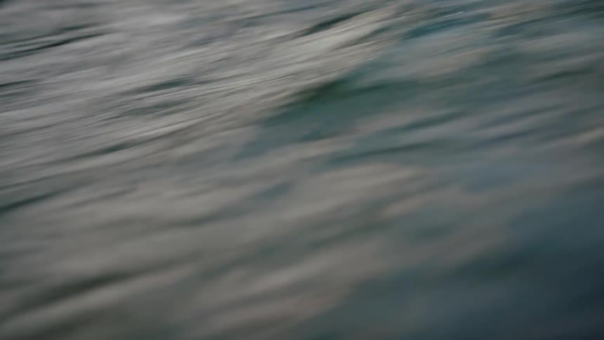 Closeup of rippling water along the riverbank