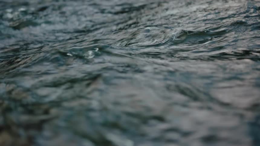 A rivers water surface ripples and flows