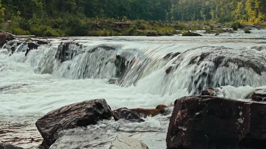 A river streaming over rocks forming rapids