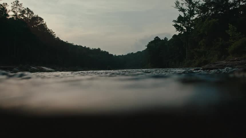 The surfaces of a river with fast water and then there is an underwater view