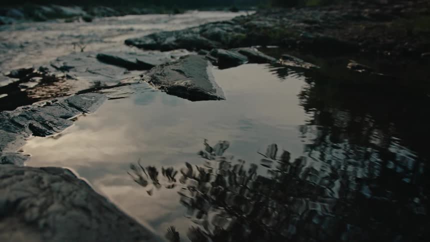 The sky reflects on the creek water