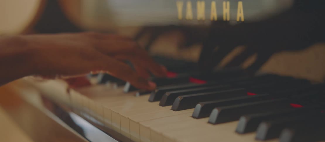 Young man sitting playing piano