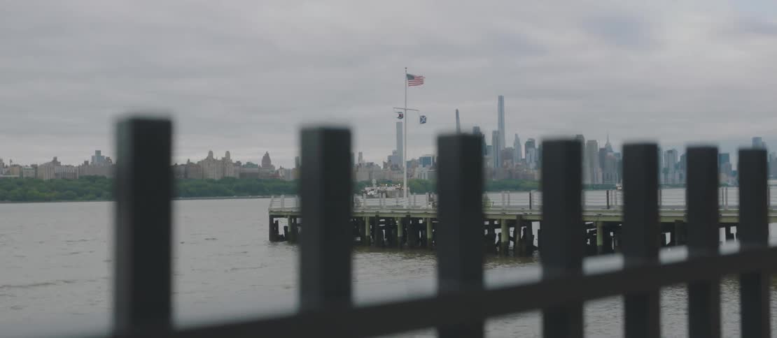 A small pier with an american flag hanging from a flagpole