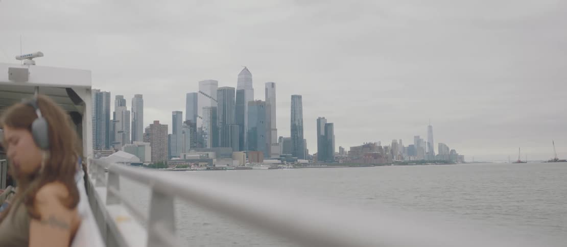 Cityscape with highrise buildings and a hazy atmosphere observed from a ferry
