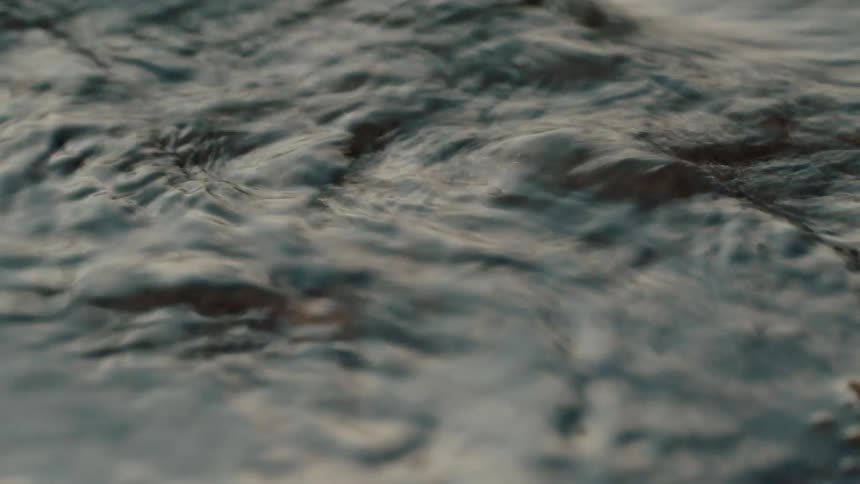 River water flows over pebbles