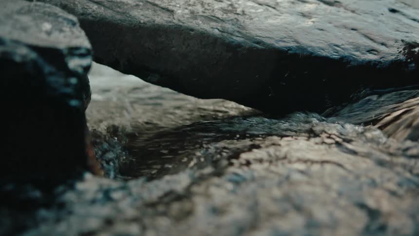 Water of a river flowing between rocks