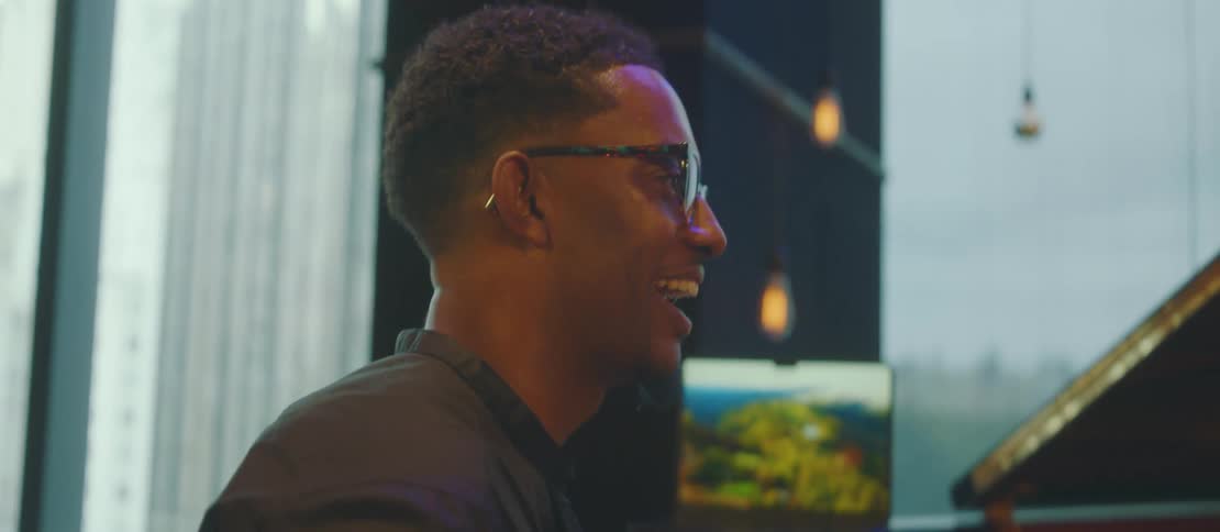 Cheerful man playing piano and talking