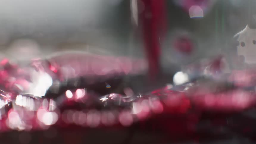 A red wine filling a clear glass container
