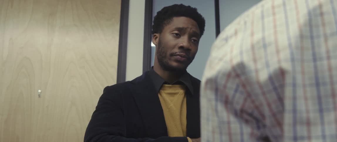 Two men indoors talking