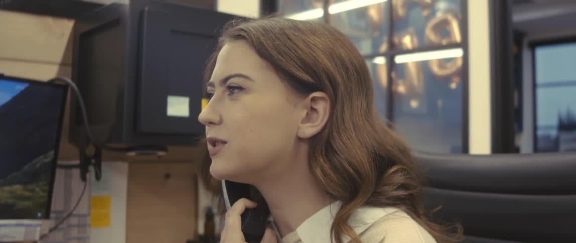 Woman in an office environment talking on the phone