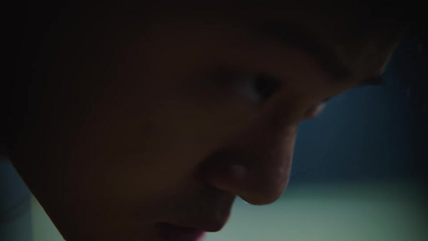 An asian stares with determination while bent over